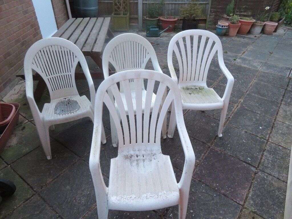 4 white plastic patio chairs