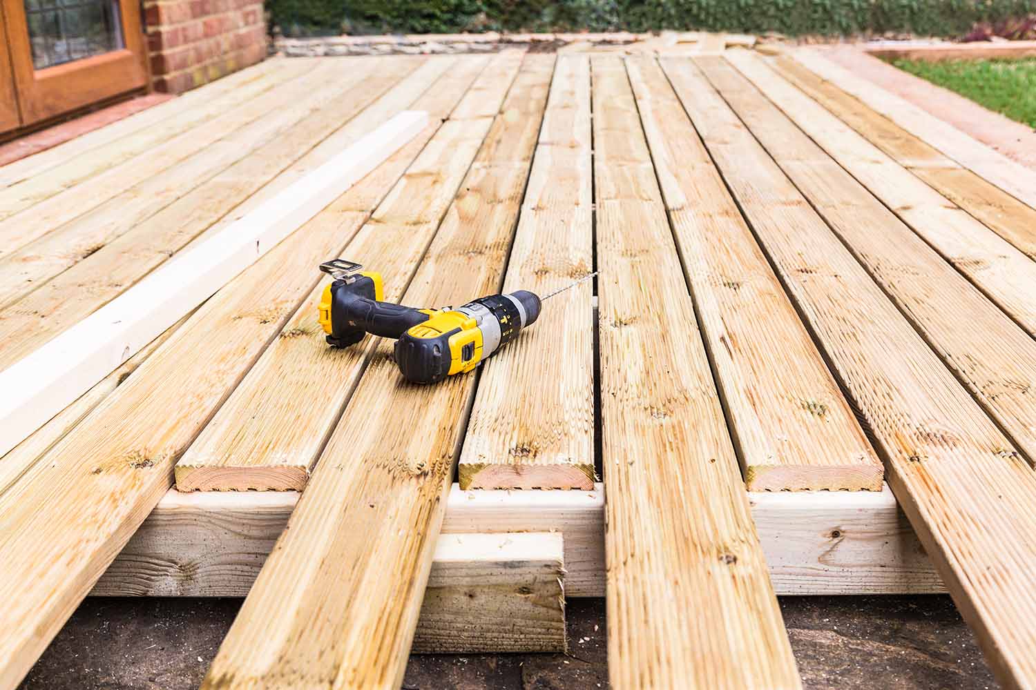 Is it cheaper to build a deck or patio?