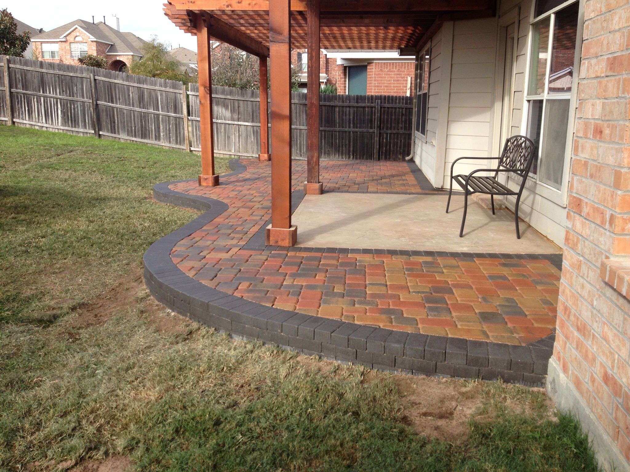 Multicolored paver patio installed around an existing ...