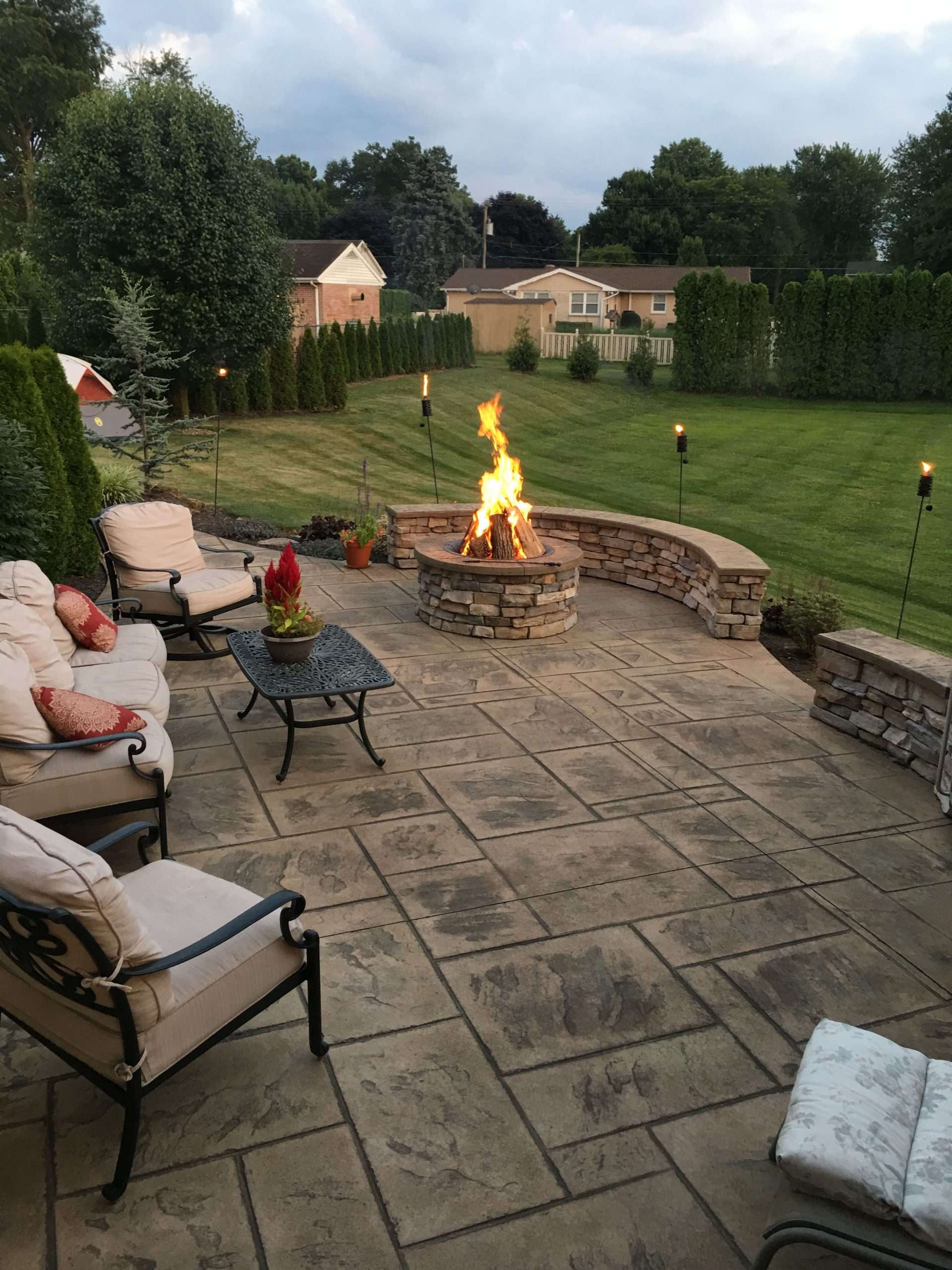 Stamped concrete patio with stone veneer wall and fire pit ...