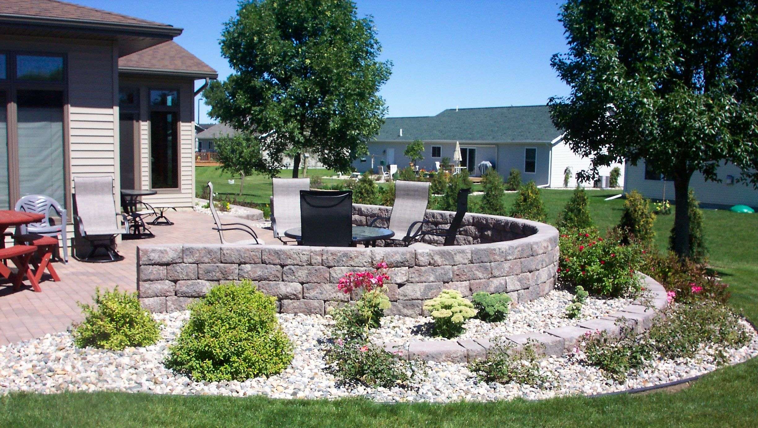 This retaining wall is a great way to enclose a patio ...